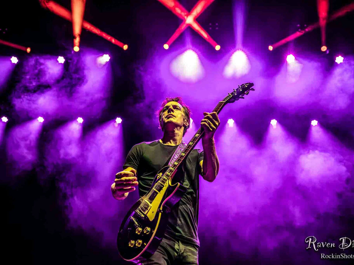 Sons of Silver guitarist under purple stage lights